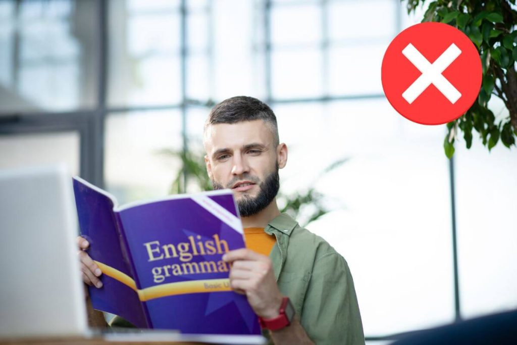 Man reading English grammar book to learn grammar